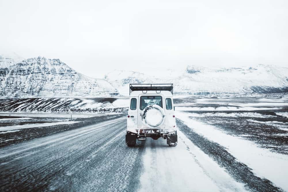 car driving on a snowy road in Iceland 