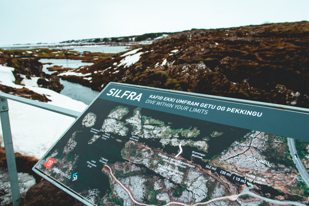 The Silfra landmark sign with snow and ice in the background