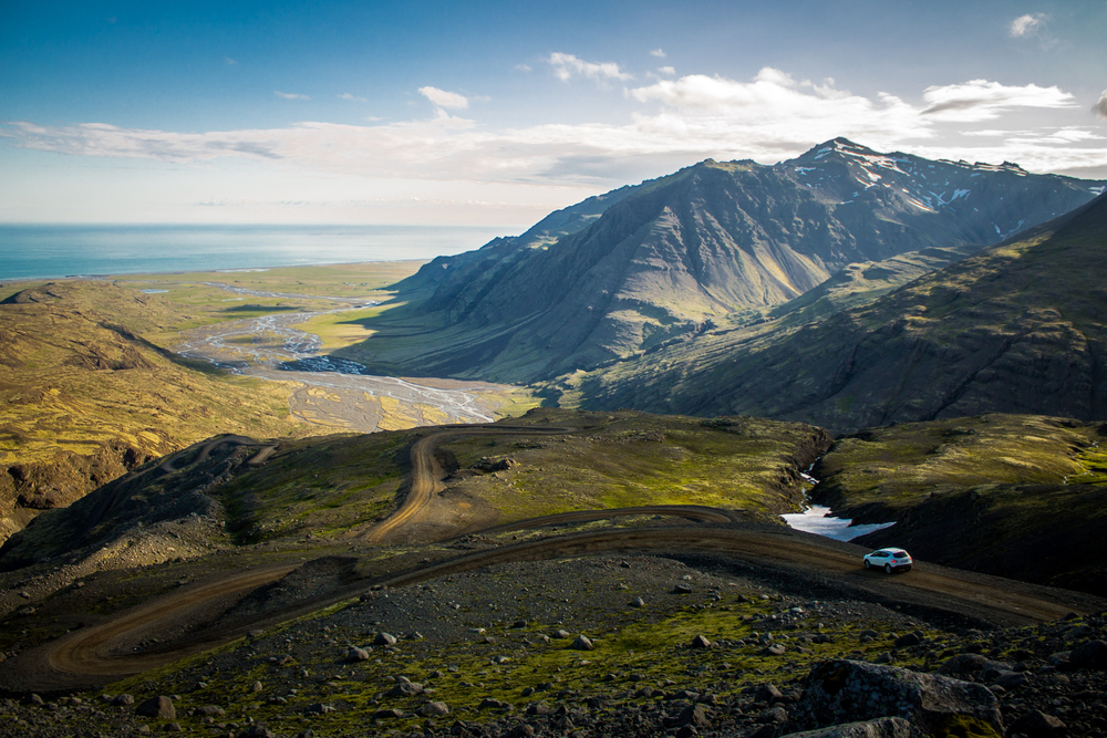 a car driving down dirt roads in Iceland 