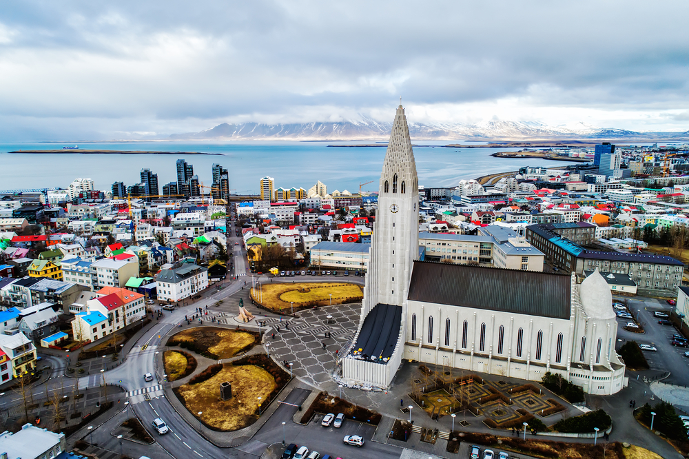 Aerial view of Reykjavik on a cloudy day featuring the Hallgrimskirkja Church.