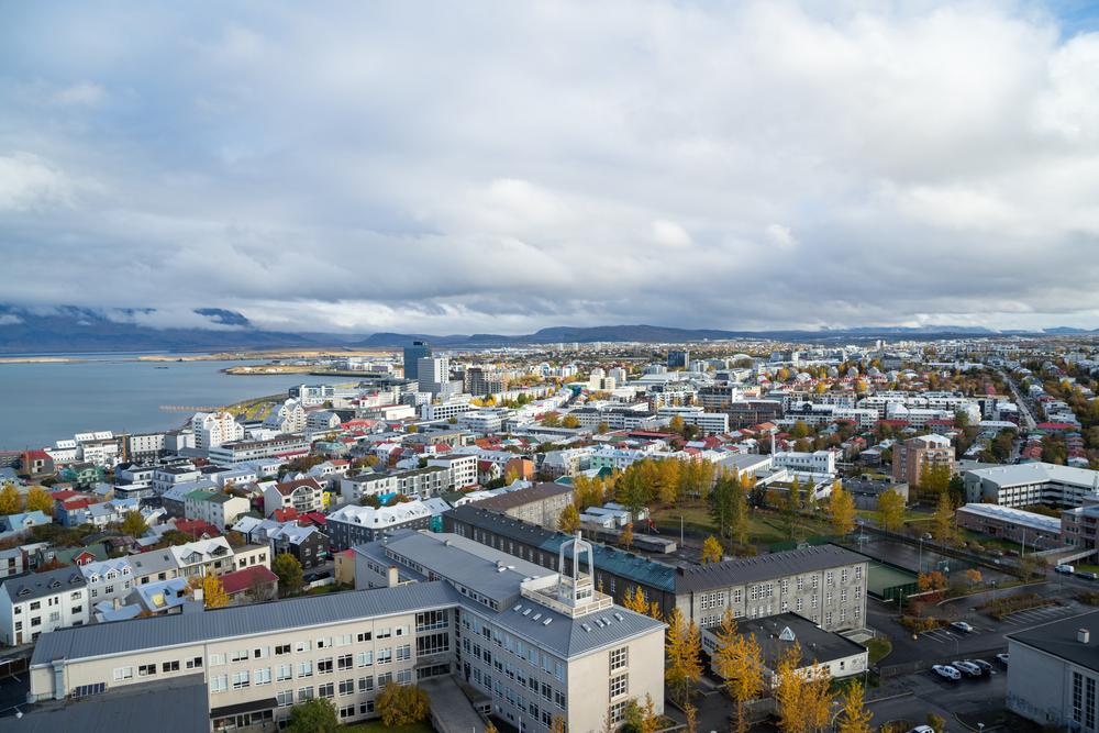 Aerial view of the Vesturbær neighborhood with fall foliage and clouds.