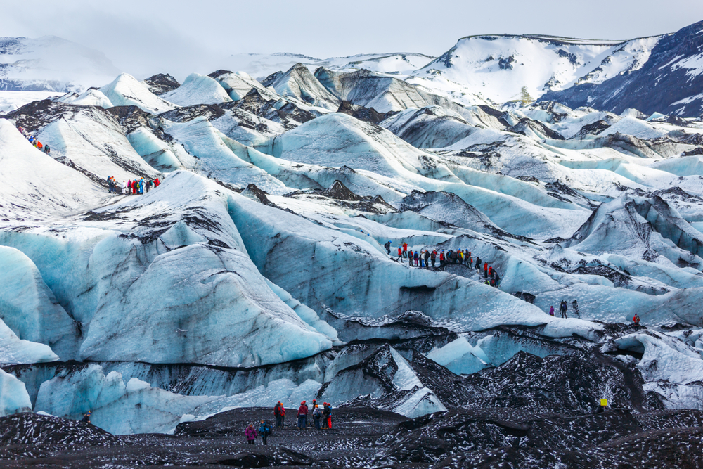 tourists hiking up the glacier Solheimajokull