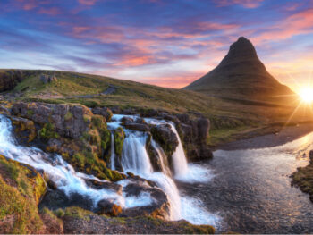 Sunset of Kirkjufell mountain with cascading waterfall nearby is a great location for movies filmed in iceland