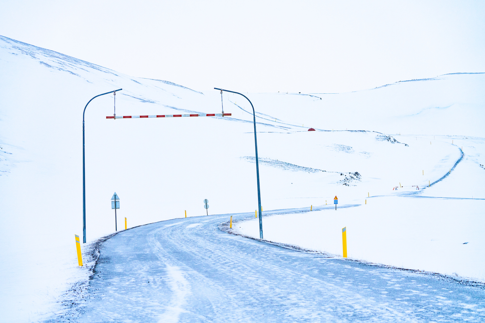 A snowy road up a mountain similar to one you'll drive from Reykjavik to Vik