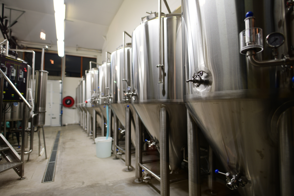 View of a brewery in Iceland with large metal brewey kegs 