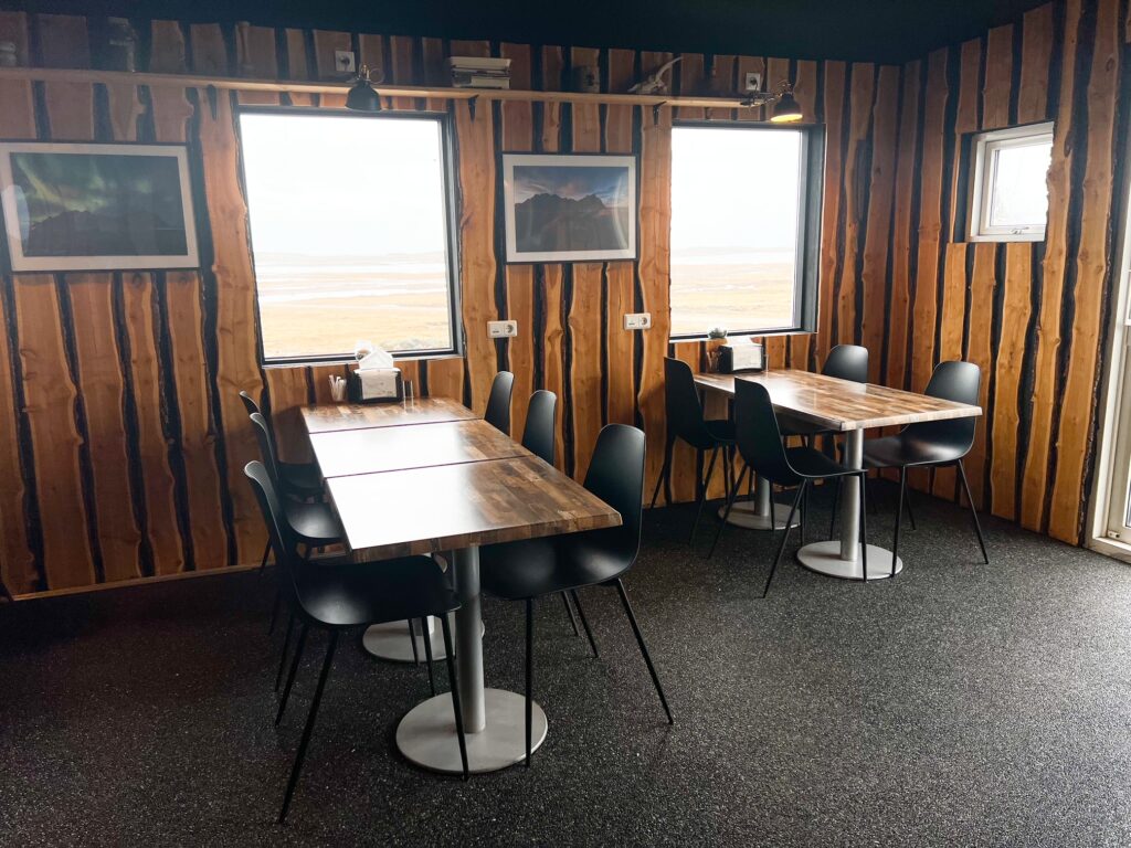 Inside the Viking Cafe with wooden walls and wooden tables in an article about coffee in Iceland