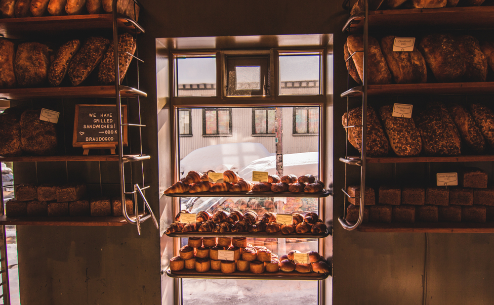 Bread piled up by a window in Brauda place to try coffee in Iceland 