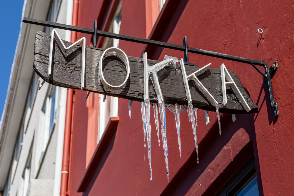 The sign of Mokka coffee with icicles hanging from it. 