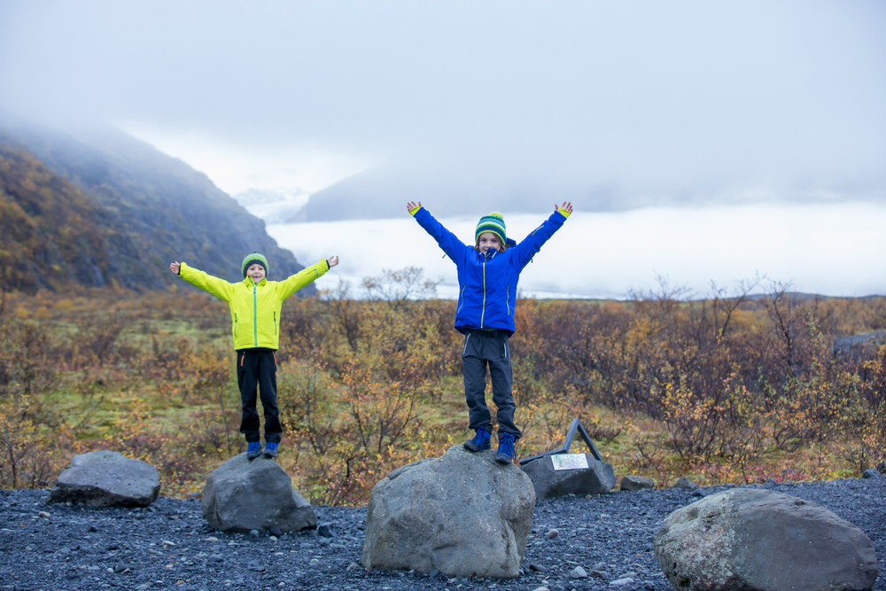 Children posing in beautiful aerial view of the nature in Skaftafell Glacier national park on a gorgeous autumn day