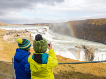 kids looking at gullfoss waterfall in iceland