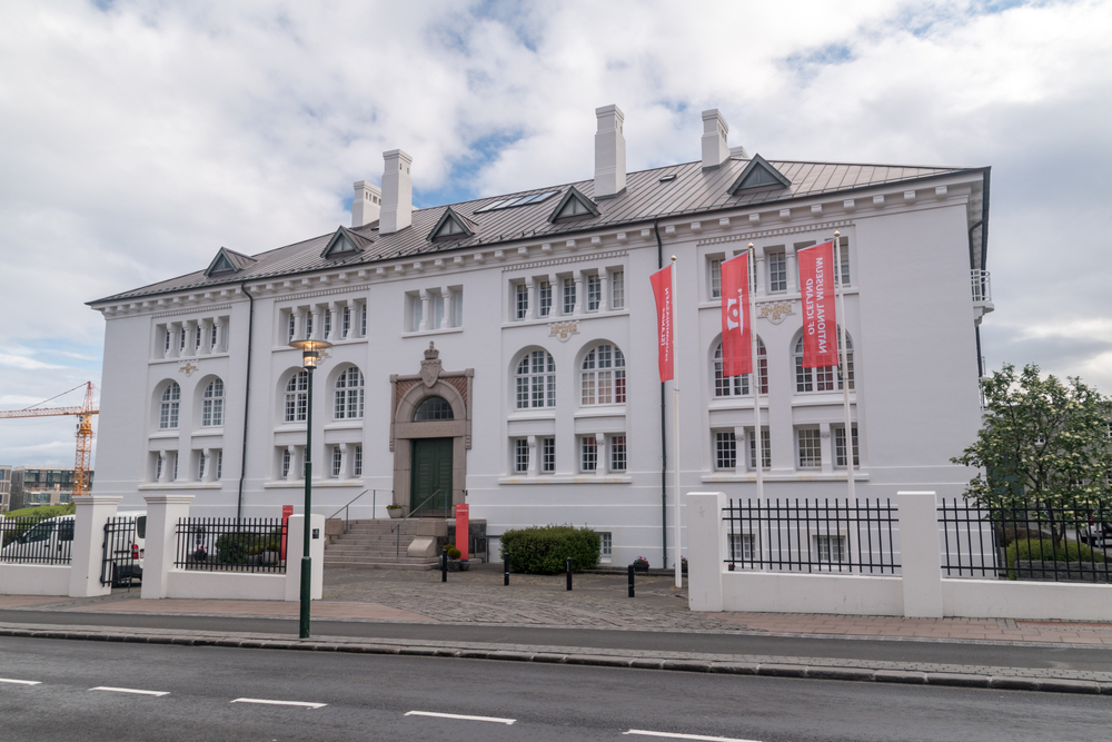  The National Museum of Iceland a large white building with arched windows. 