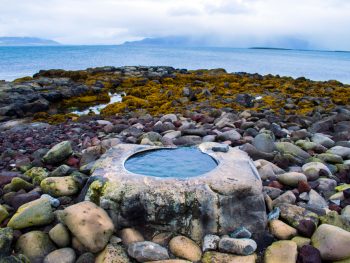 kivka footbath on rocky shore one of the best hot springs in reykjavik