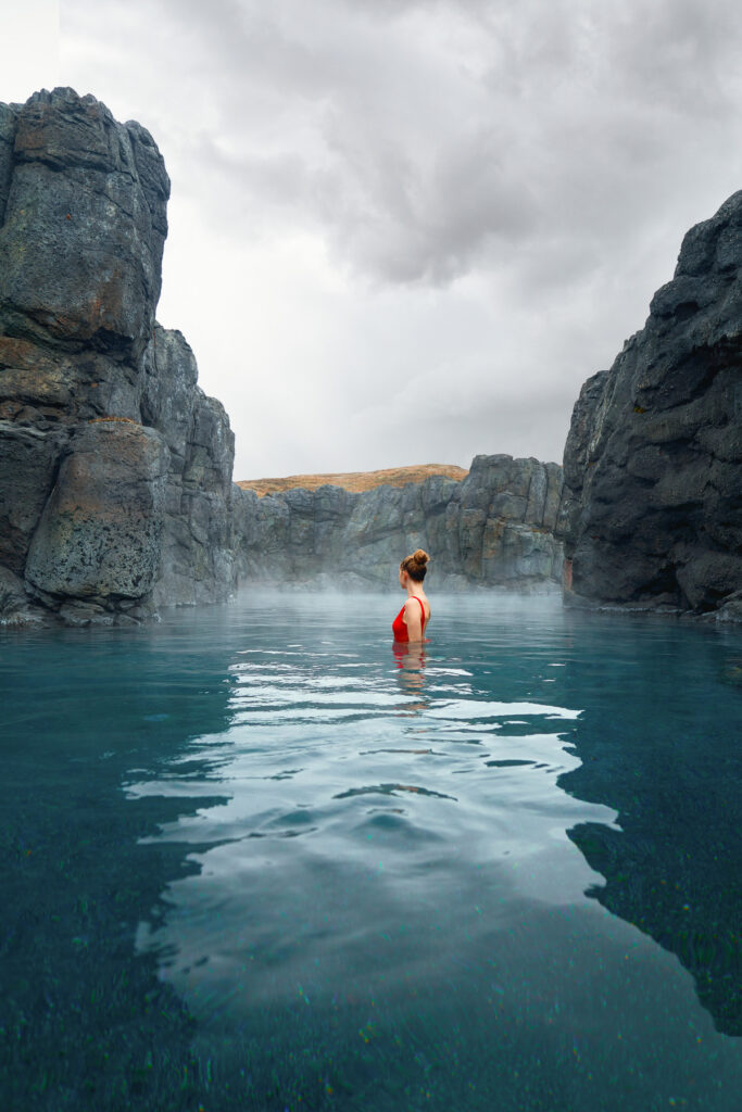 a girl standing to the side with rocks