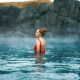 woman standing in front of sky lagoon in iceland