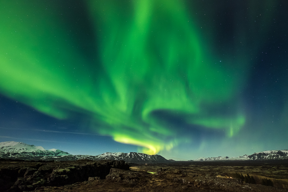 The green hues of the northern lights stretch across the night sky: but this is something you cannot see during summer in Iceland.