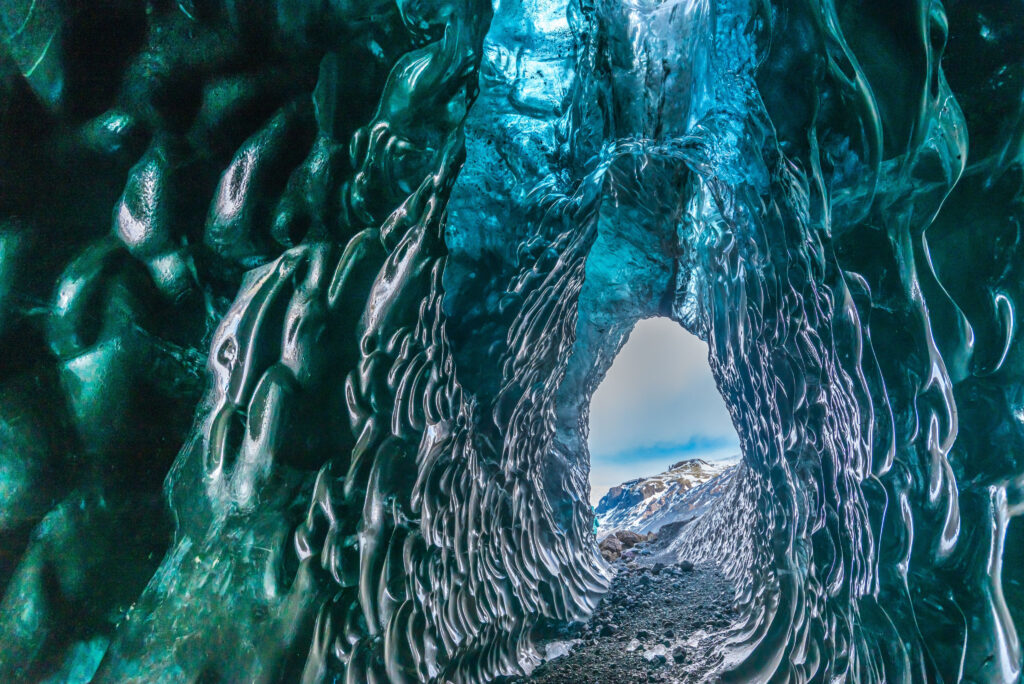 Ranging hues of blue line the hallways of the best crystal caves in Iceland