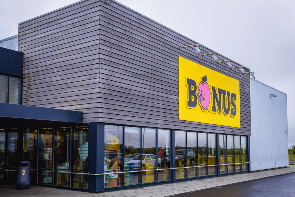 Grey colored grocery stores in Iceland are labeled with yellow big “Bonus” signs