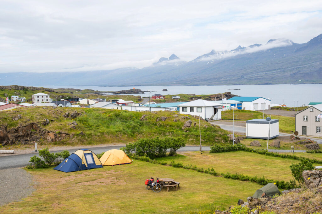 Tents pitched at a great iceland campground near the harbor overlooking the east fjords