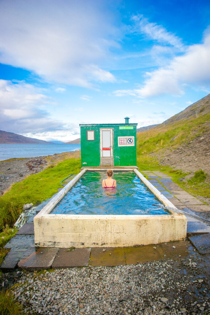 soaking in the Horgshlidarlaug Hot Spring in the Westfjords with views of the ocean and mountains