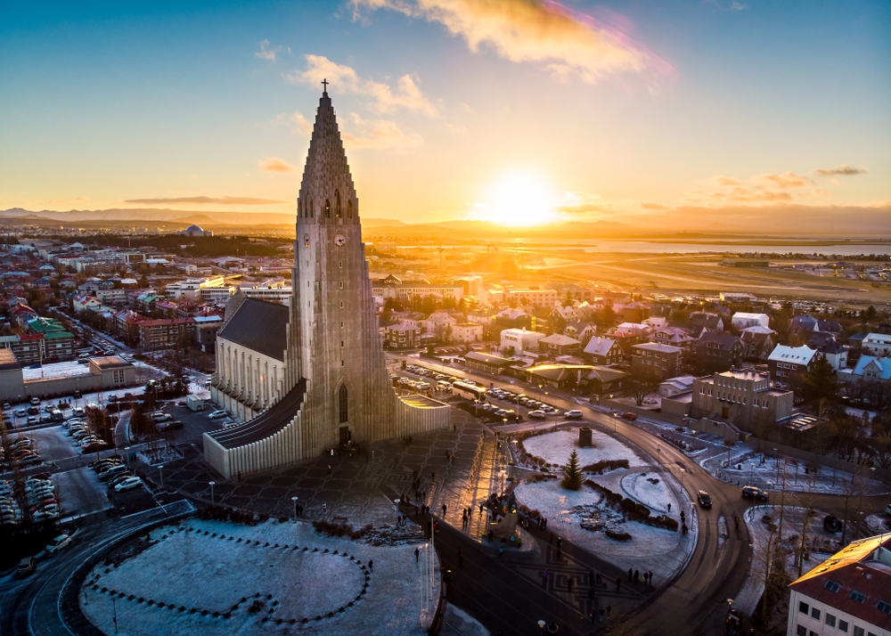 Aerial view of Hallgrimskirkja towering over Reykjavik at sunset.