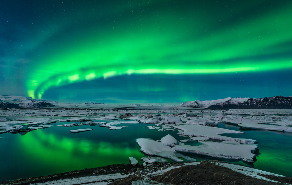 Green northern lights over a glacier lagoon during 3 days in Iceland.