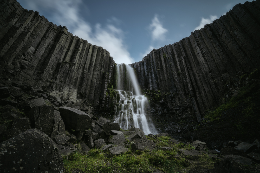 the gentle cascades of studlafoss flowing over the black basalt columns