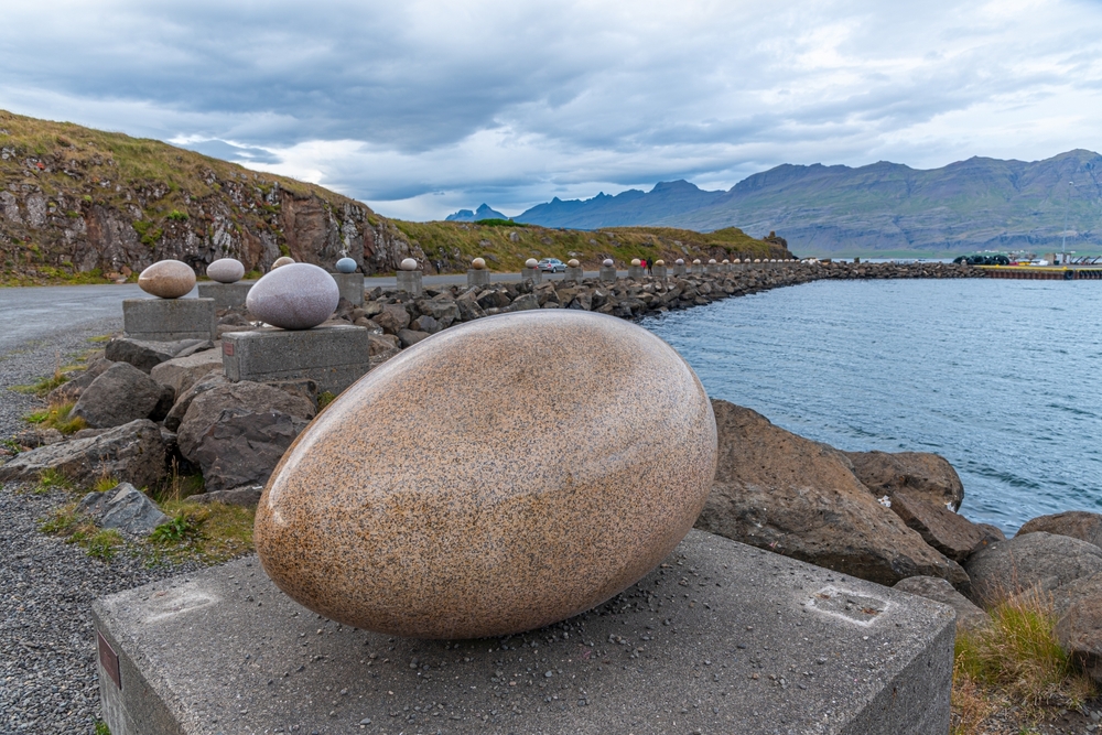 thirty-four giant stone eggs line the shore, each representing a local bird species.